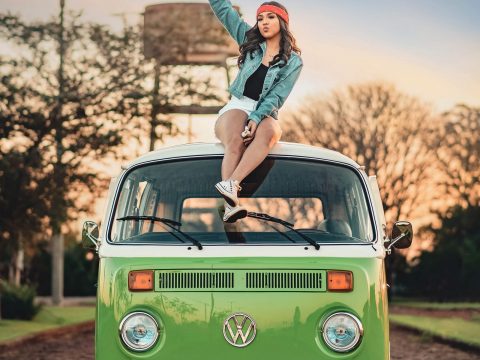 Woman Sitting on Top of Volkswagen