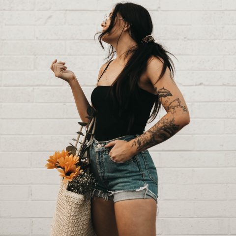 Woman Wearing Blue Denim Shorts and Black Spaghetti-strap Tank Top