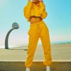 Woman in Yellow Tracksuit Standing On Basketball Court Side