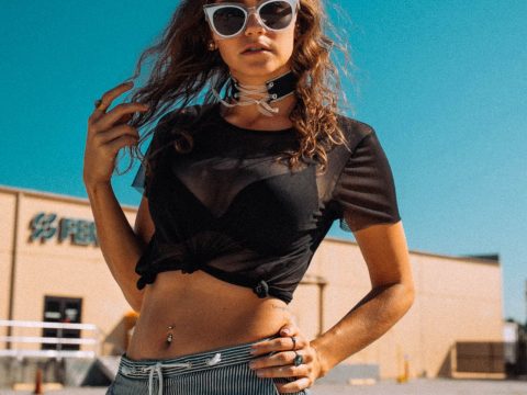 Woman Wearing White Framed Sunglasses and Black Mesh Shirt