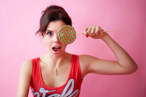 Photo of Woman Holding Lollipop