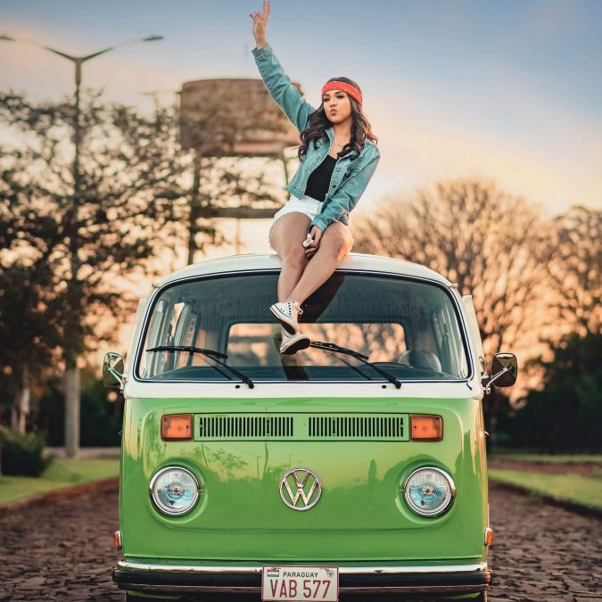 Woman Sitting on Top of Volkswagen