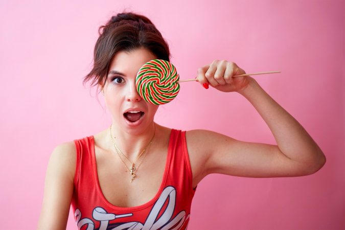 Photo of Woman Holding Lollipop
